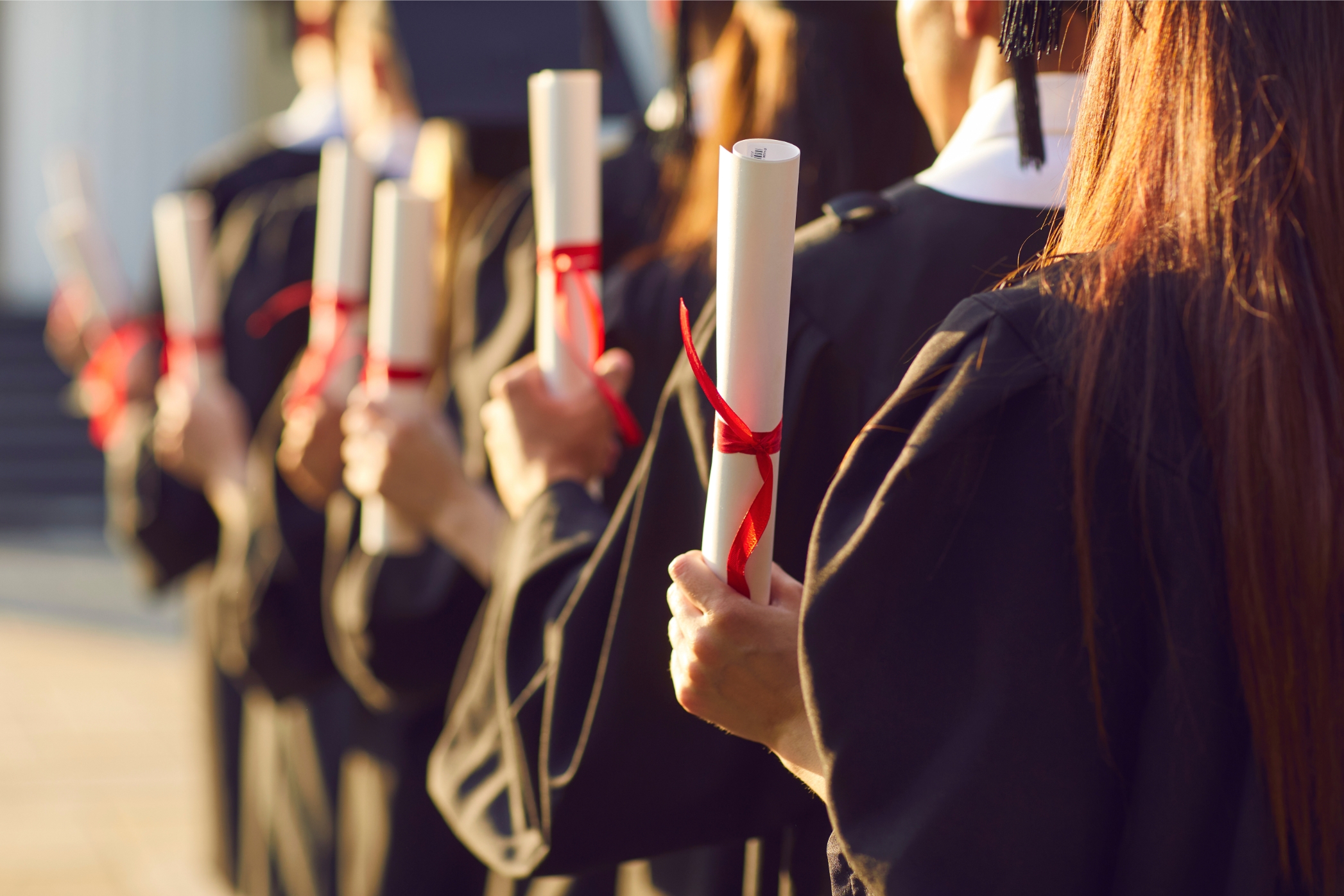 Graduates holding their degrees