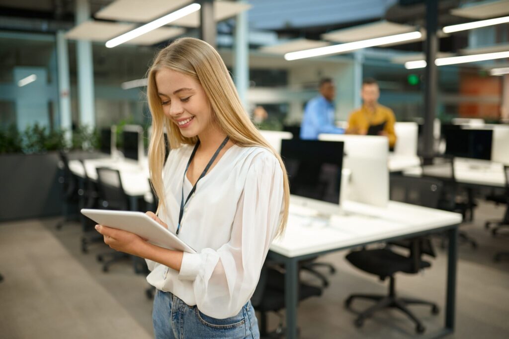 Young female apprentice smiling on tablet