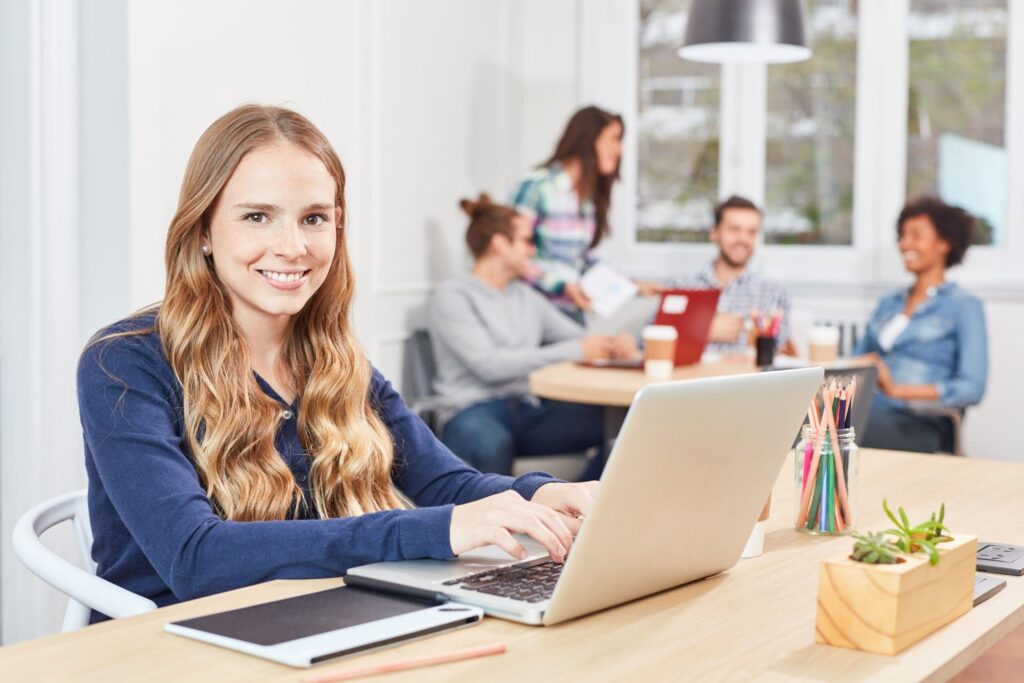 Young female apprentice working on a laptop