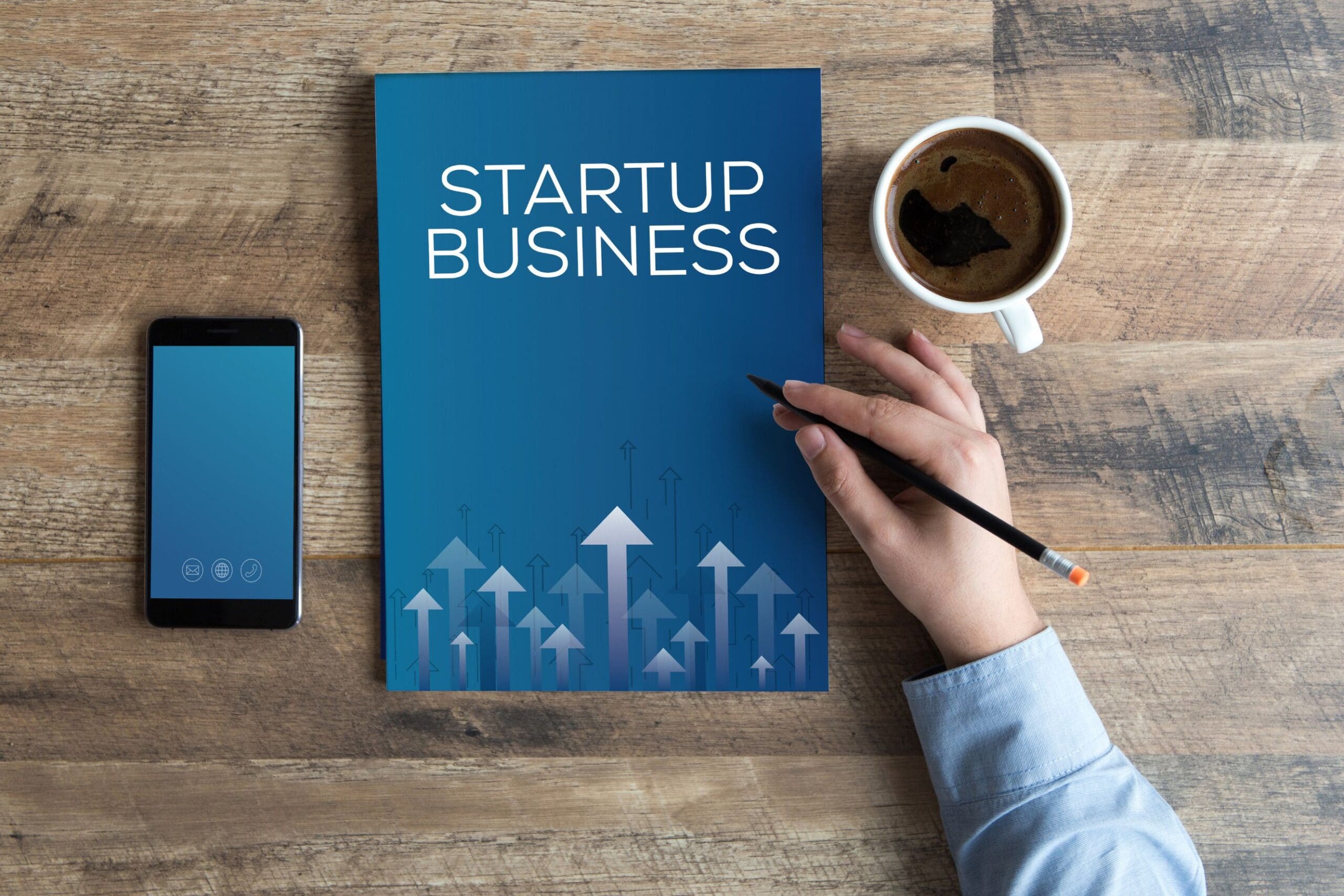 Man with startup business book and cup of coffee