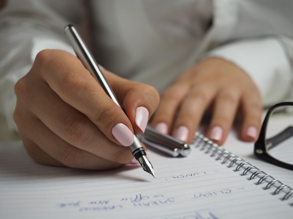 Woman prepping for interview writing notes