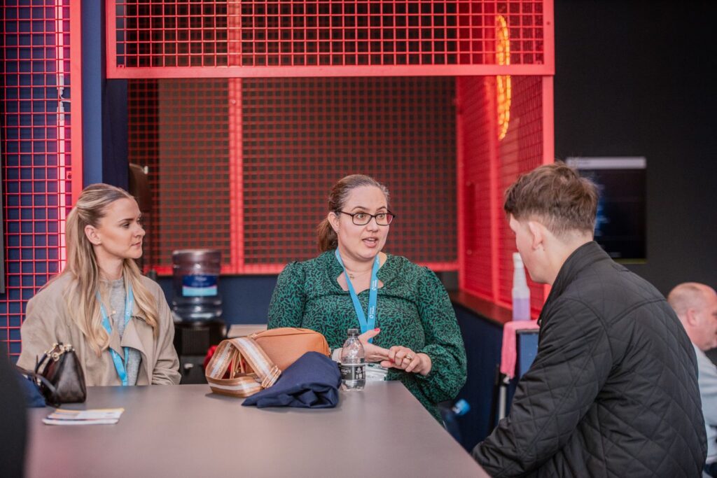 Teaching Assistant apprentice with mentor speaking to a student