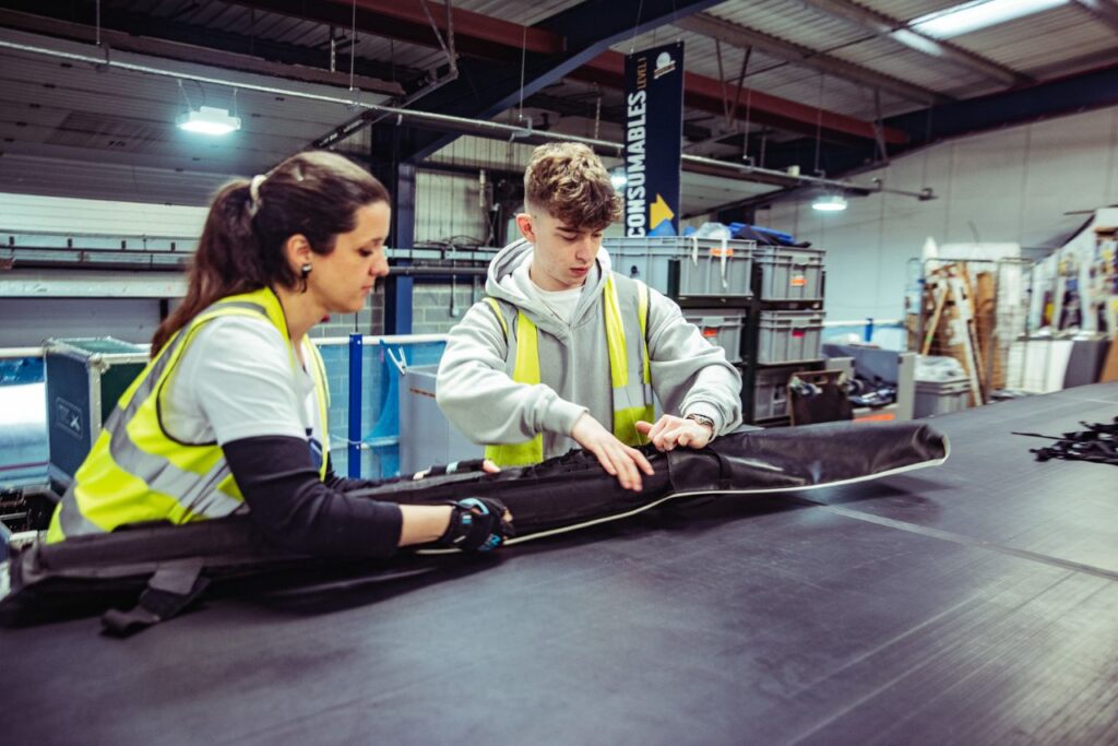 Lighting Technician apprentices working together on a lighting in workshop