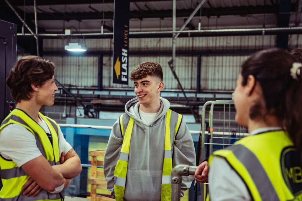 Lighting Technician apprentices talking to each other, smiling
