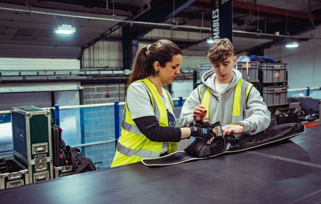 Screen Lighting Technician apprentice working with manager